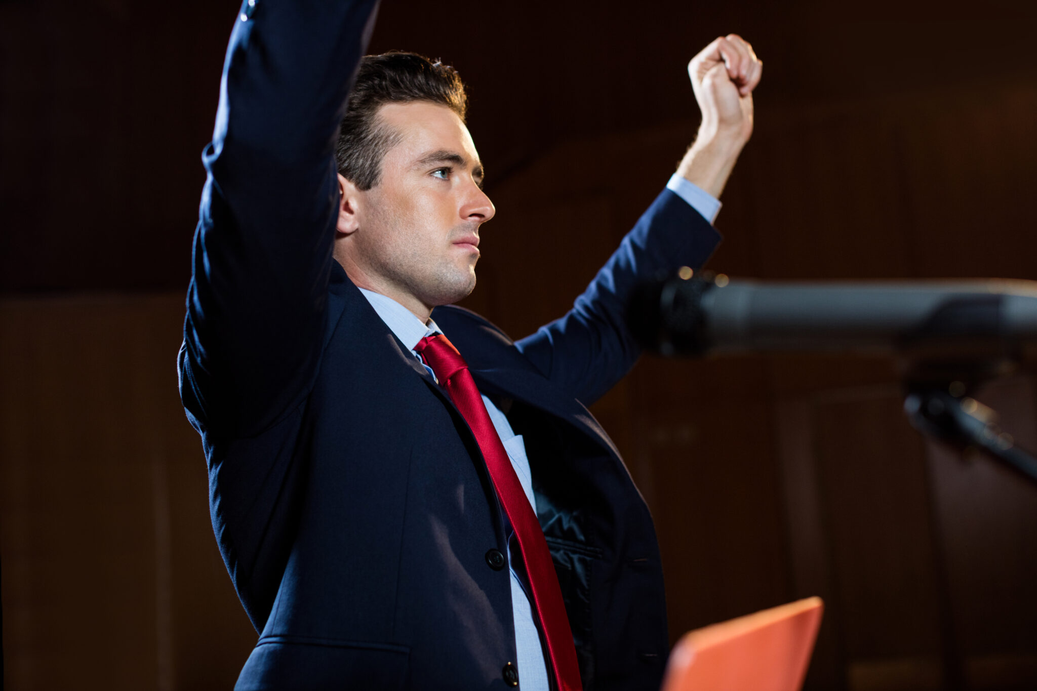 Male business executive giving a speech at conference center