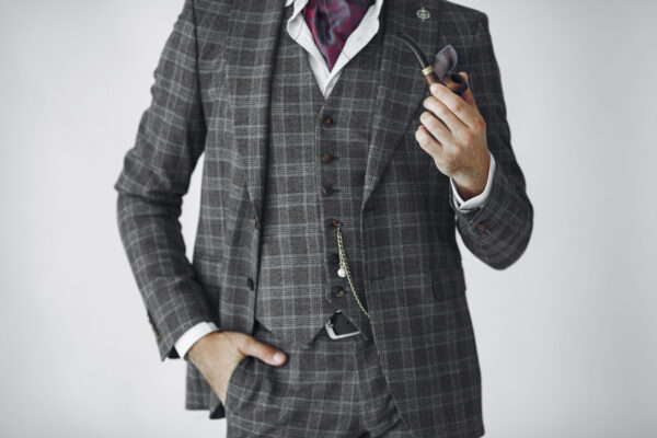 Portrait of bearded redhead English male. Senior smoking pipe in a studio.